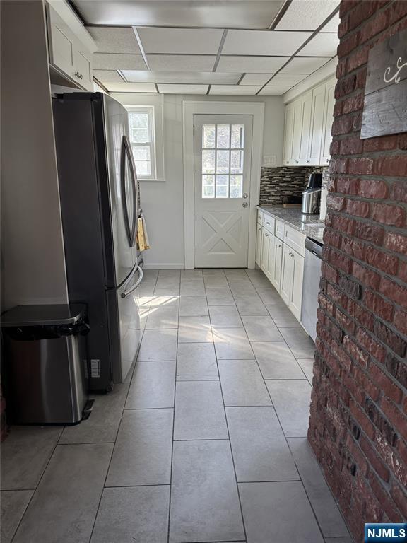 908 Linden Avenue Ridgefield, NJ 07657 - Photo 6 of 8 a kitchen with stainless steel appliances granite countertop a refrigerator and a stove
