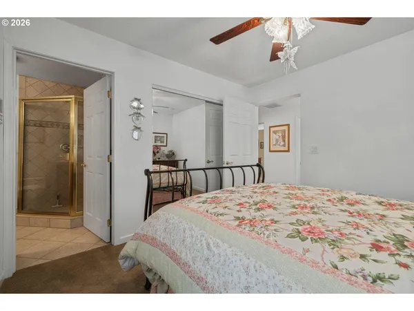 a bedroom with a bed and a mirror