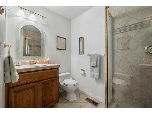a bathroom with a sink a toilet and mirror