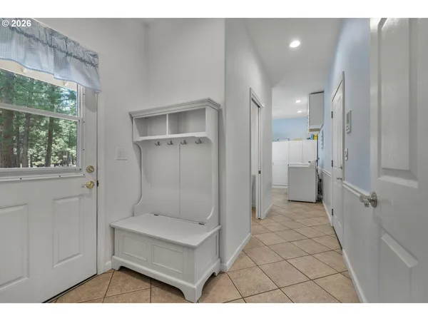 a view of a hallway and a livingroom with furniture