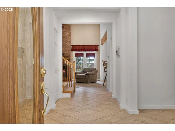 a view of a hallway with a livingroom and furniture