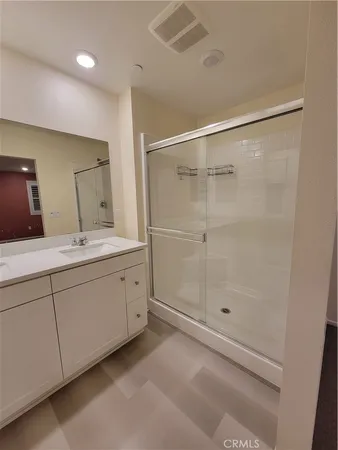 a bathroom with a double vanity sink and a mirror