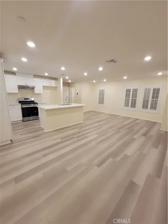 a large white kitchen with a sink and cabinets