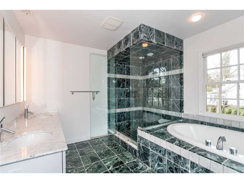 5 Dorchester Lane Riverside, CT 06878 - Photo 13 of 22 a bathroom with a tub a sink and a large window