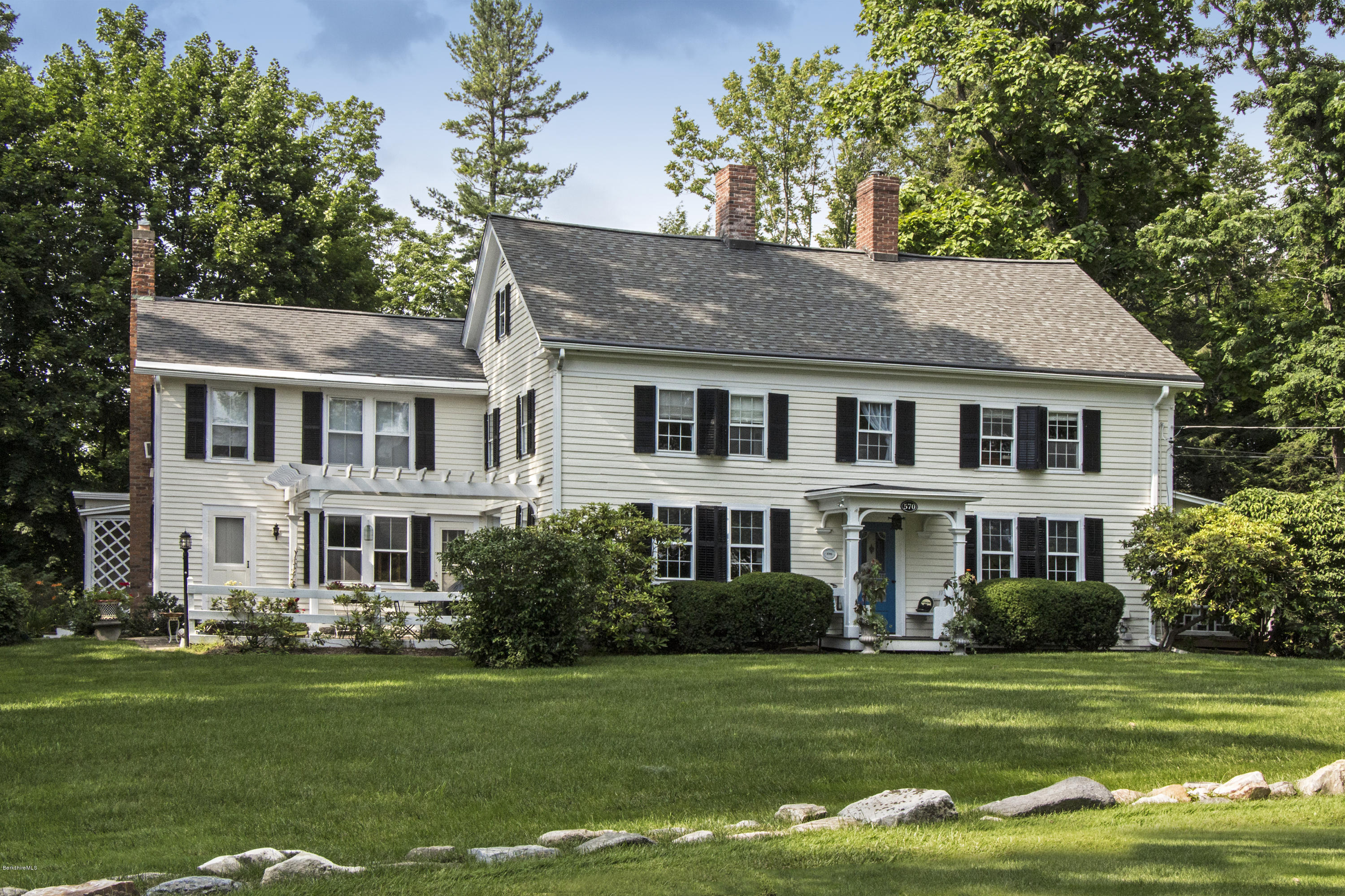 570 Devon Road Lee, MA 01238 - Photo 1 of 42 a front view of a house with a garden