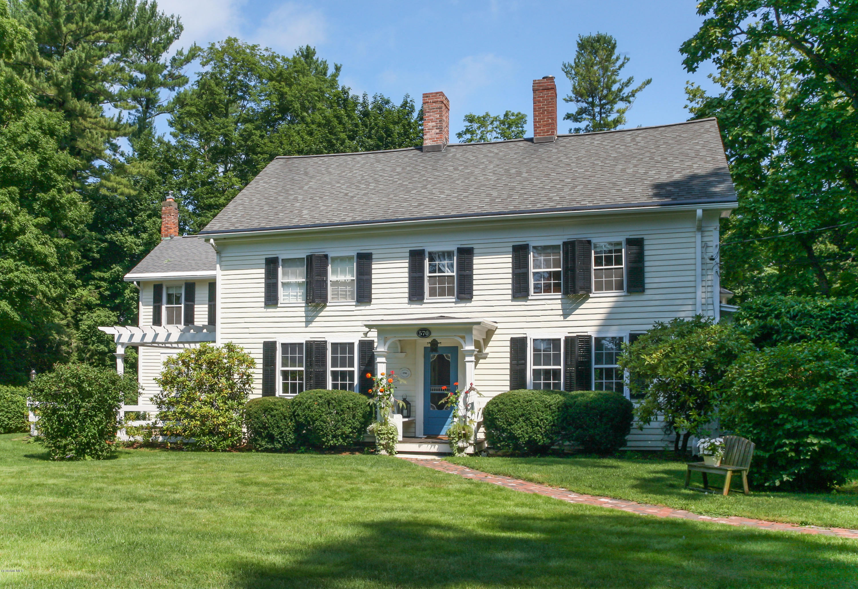 570 Devon Road Lee, MA 01238 - Photo 14 of 42 a front view of a house with a yard and garage