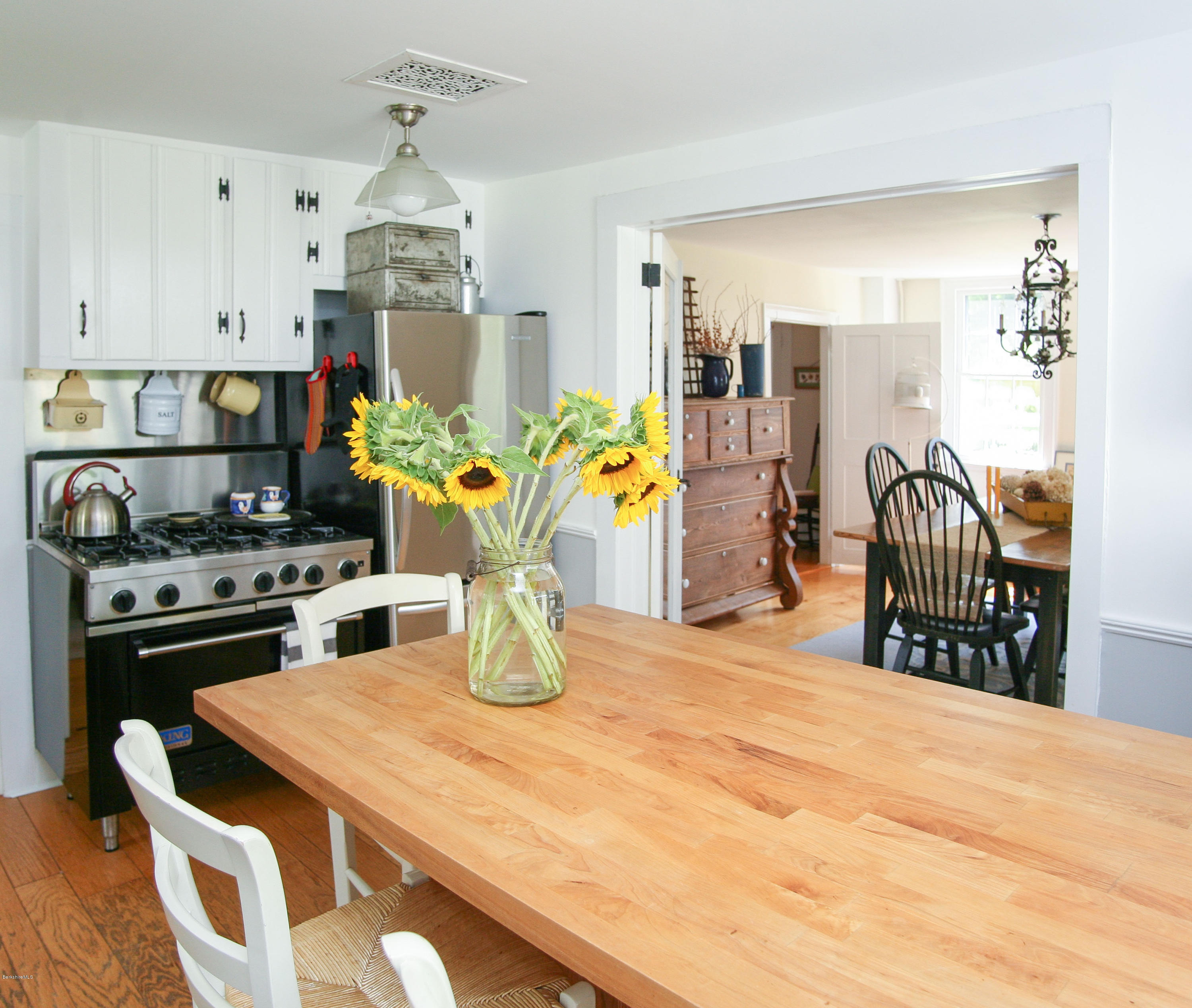 570 Devon Road Lee, MA 01238 - Photo 21 of 42 a kitchen with a stove and a dining table