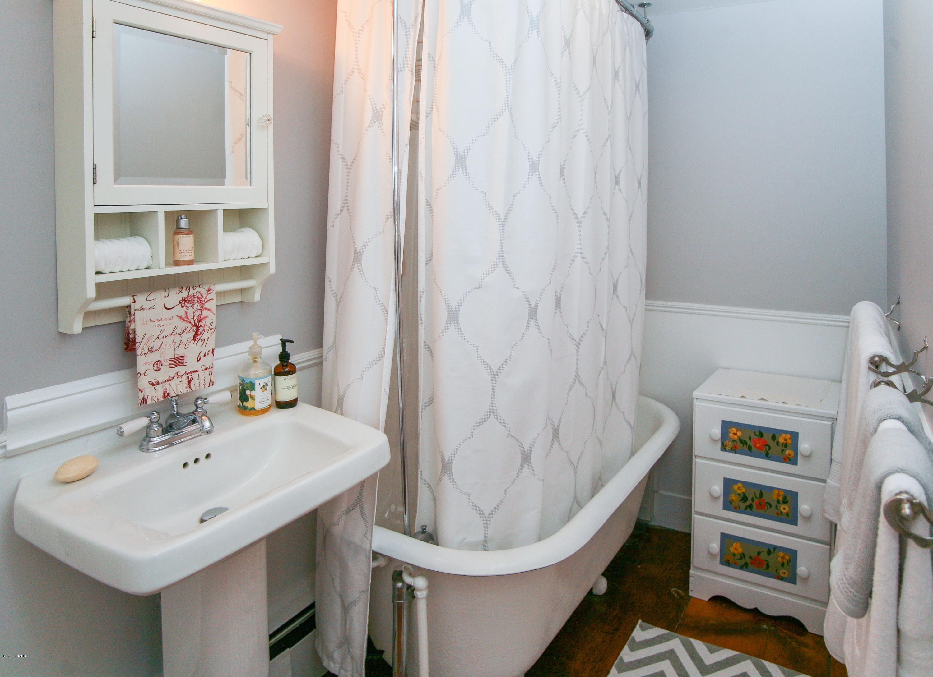 570 Devon Road Lee, MA 01238 - Photo 32 of 42 a bathroom with a sink a toilet and shower curtain