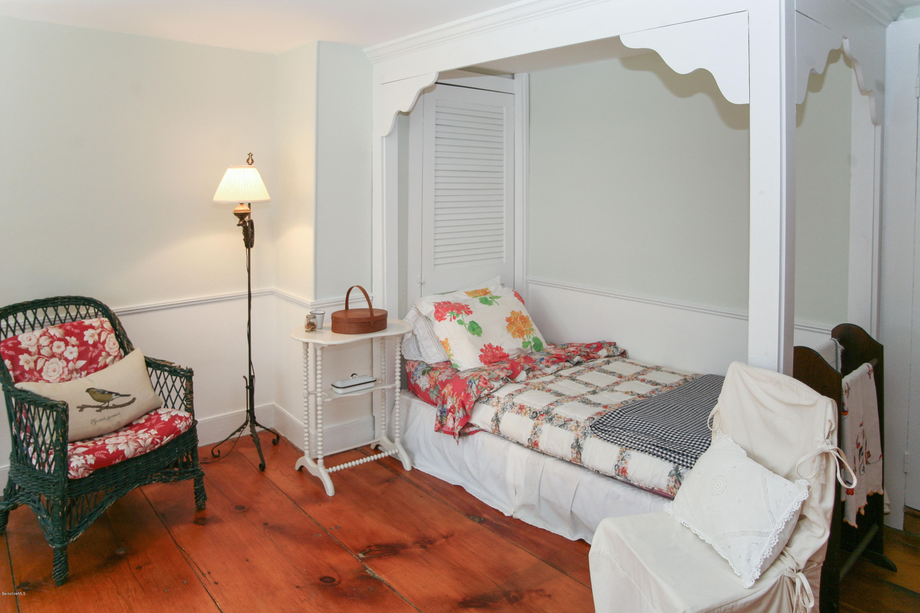570 Devon Road Lee, MA 01238 - Photo 33 of 42 a bedroom with a bed and a chandelier
