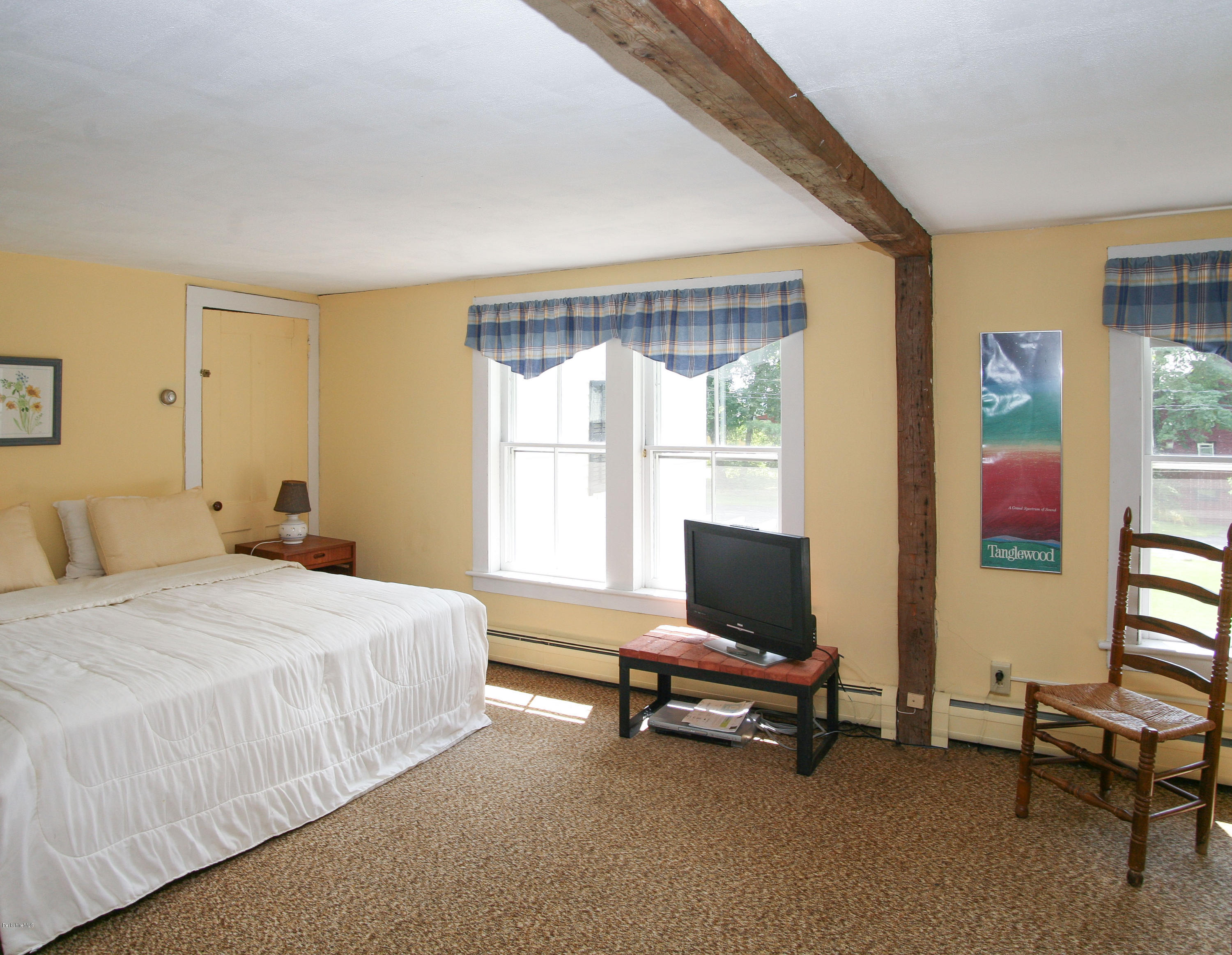 570 Devon Road Lee, MA 01238 - Photo 36 of 42 a bedroom with a bed and large windows