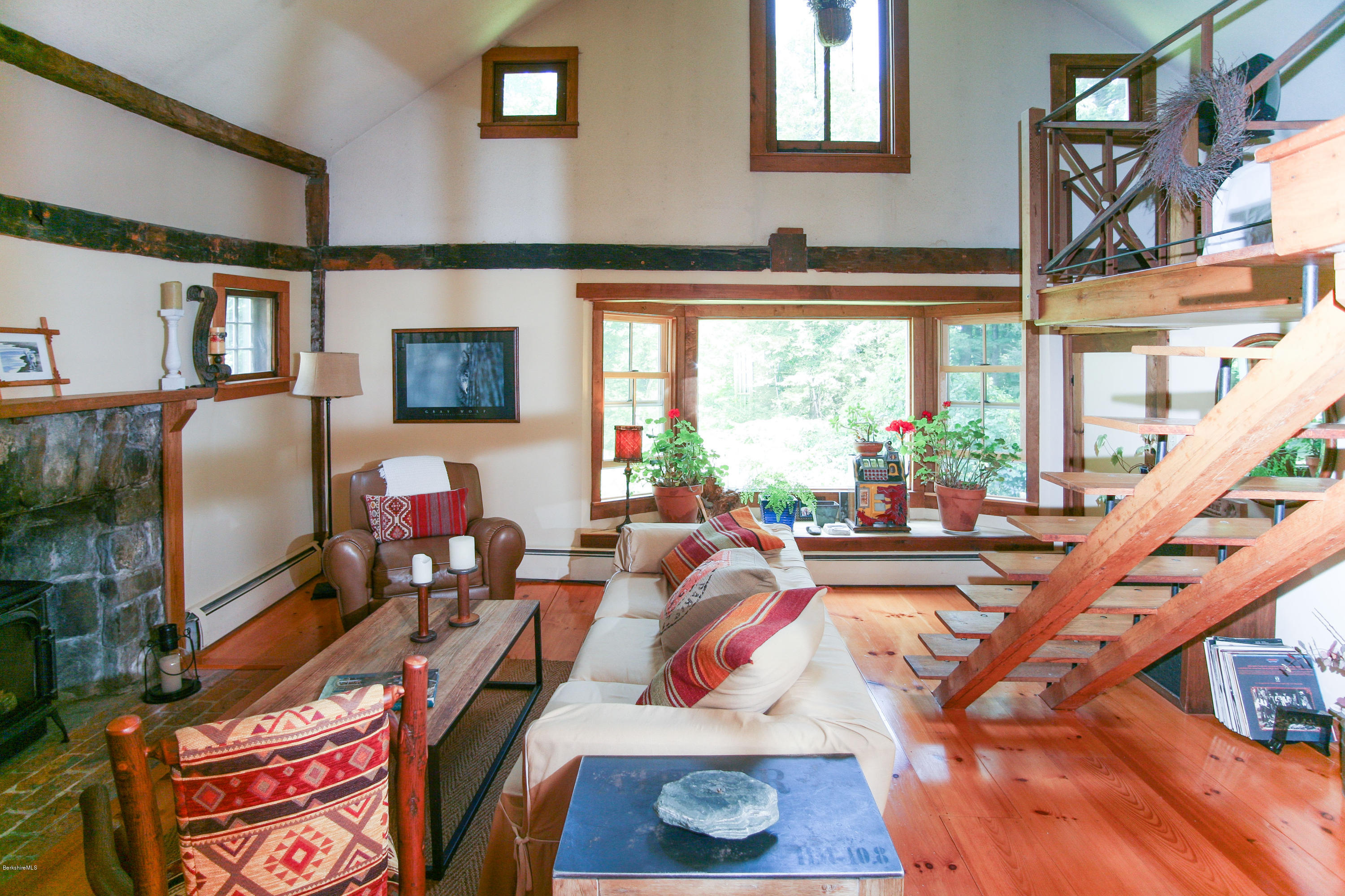 570 Devon Road Lee, MA 01238 - Photo 38 of 42 a living room with furniture a flat screen tv and a floor to ceiling window