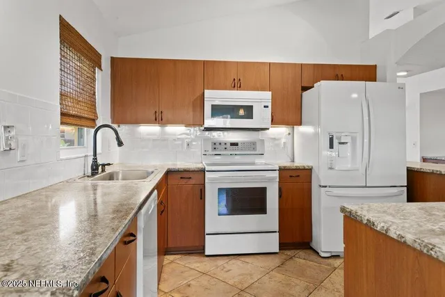 an empty room with a window and a ceiling fan