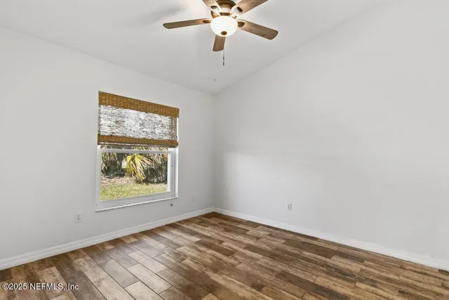 a bathroom with a bathtub shower sink vanity mirror and toilet