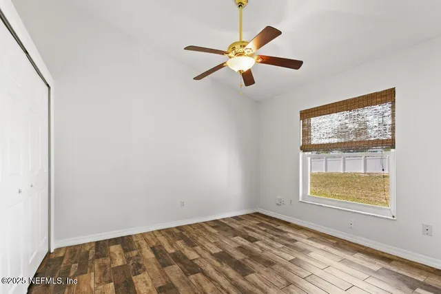 a view of an empty room with a fireplace and a flat screen tv