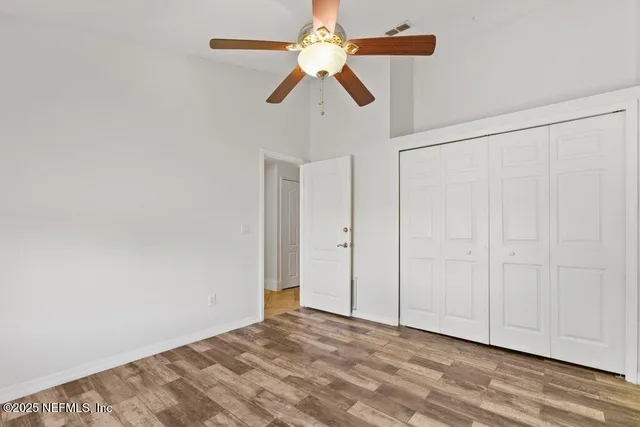 a view of a livingroom with a fireplace and a ceiling fan