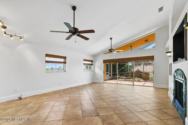 a view of a livingroom with a ceiling fan and window