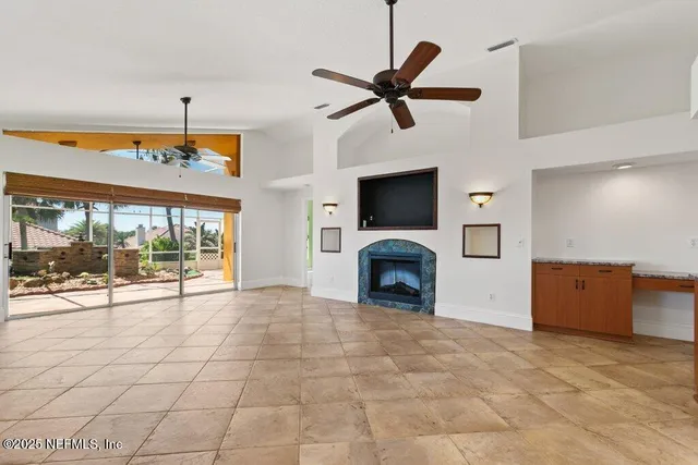 a room with a large window and bed