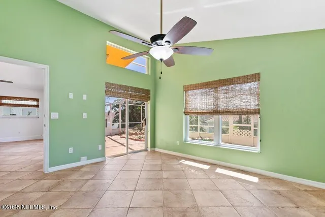 a view of living room with furniture and a ceiling fan