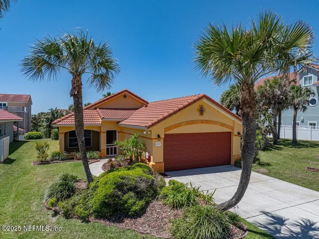a large kitchen with stainless steel appliances kitchen island granite countertop a table and chairs in it