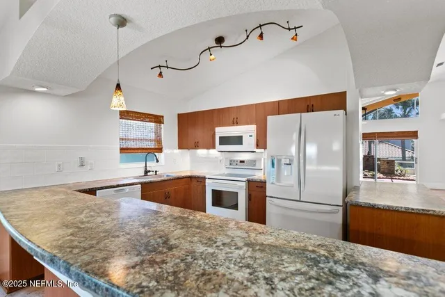a view of living room with granite countertop cabinets and fireplace