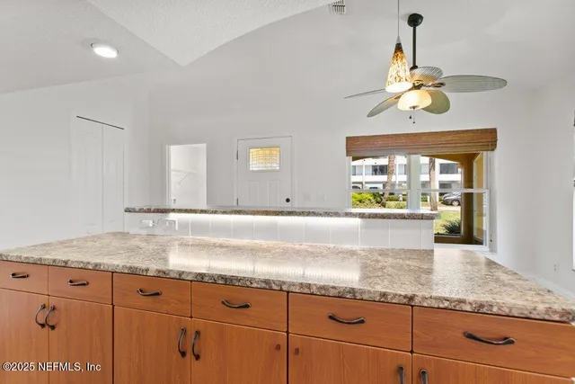 a kitchen with stainless steel appliances granite countertop a sink and a stove