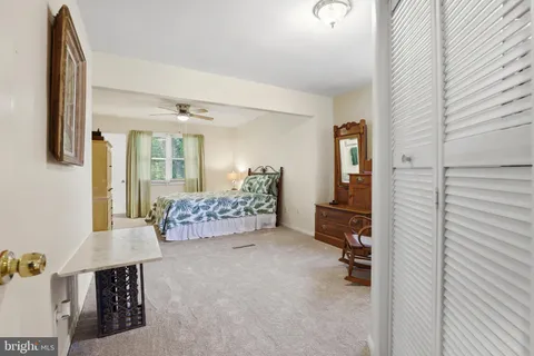 a bedroom with a bed chair and window
