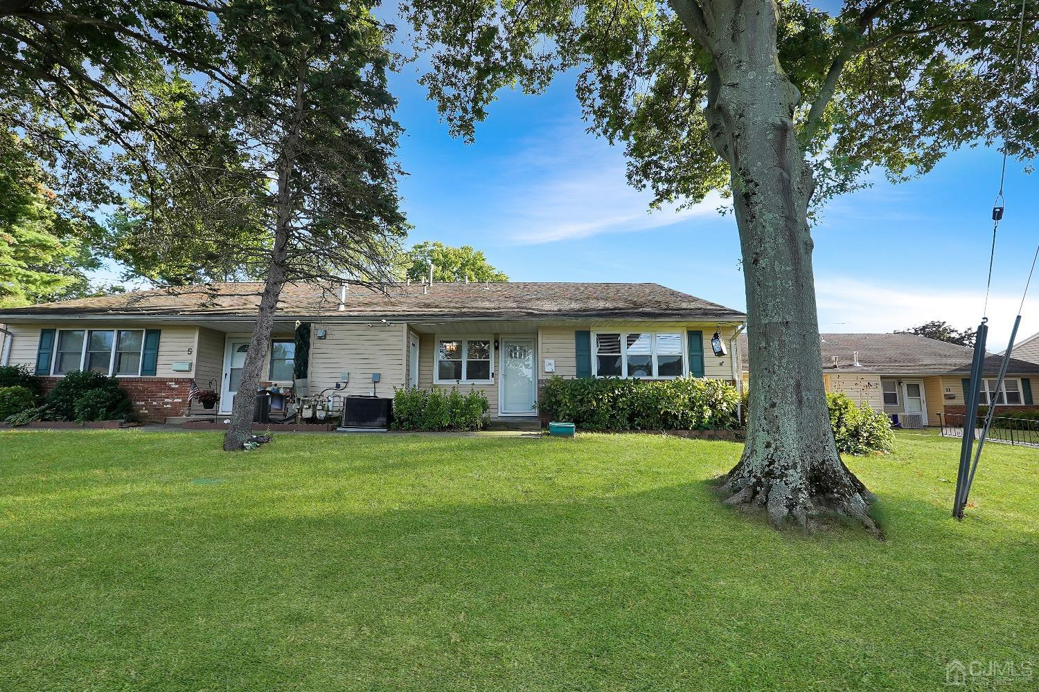 7 Haven Drive Old Bridge, NJ 07747 - Photo 3 of 24 a front view of a house with garden and trees
