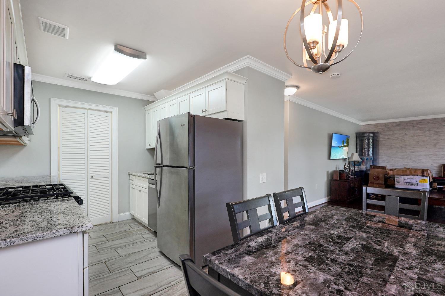 7 Haven Drive Old Bridge, NJ 07747 - Photo 7 of 24 a kitchen with stainless steel appliances granite countertop a refrigerator a stove and a sink with granite countertops