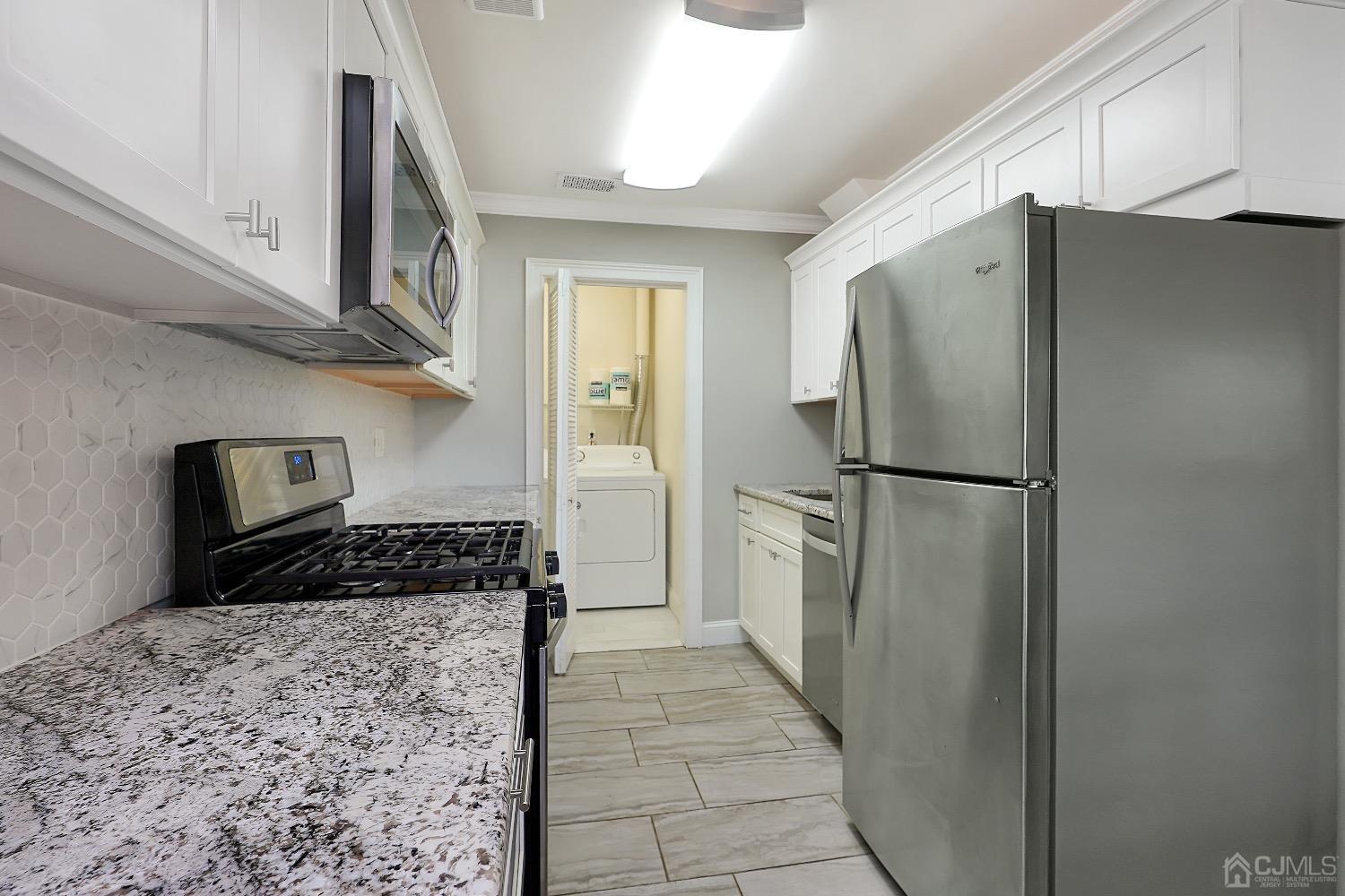 7 Haven Drive Old Bridge, NJ 07747 - Photo 9 of 24 a kitchen with a refrigerator and a stove top oven