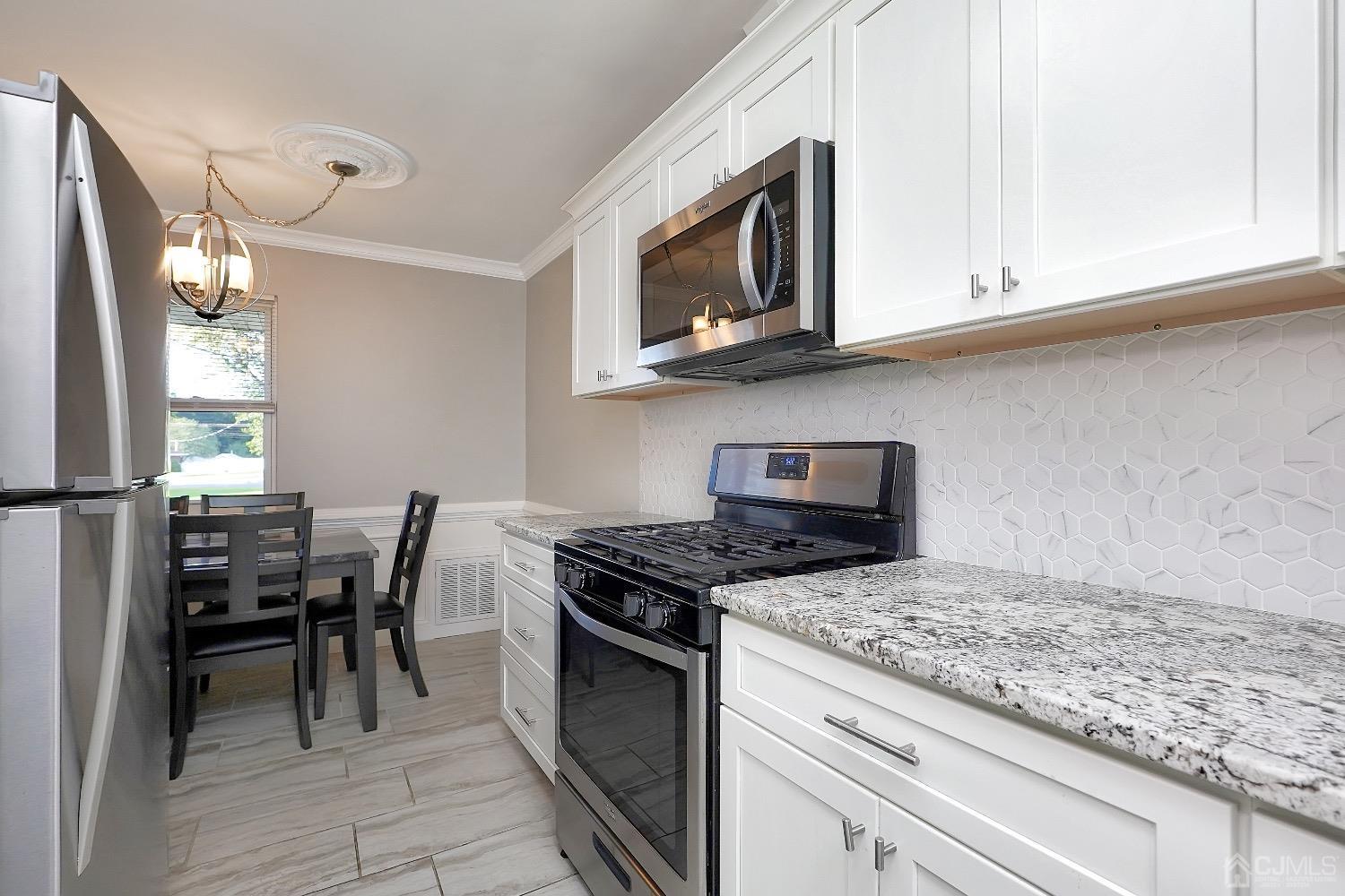 7 Haven Drive Old Bridge, NJ 07747 - Photo 10 of 24 a kitchen with granite countertop wooden cabinets and stainless steel appliances