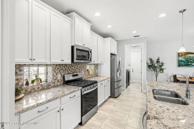 a kitchen with center island and stainless steel appliances