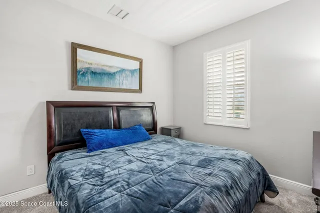 a dining room with furniture and a floor to ceiling window