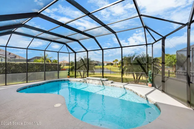 a view of a swimming pool with a yard