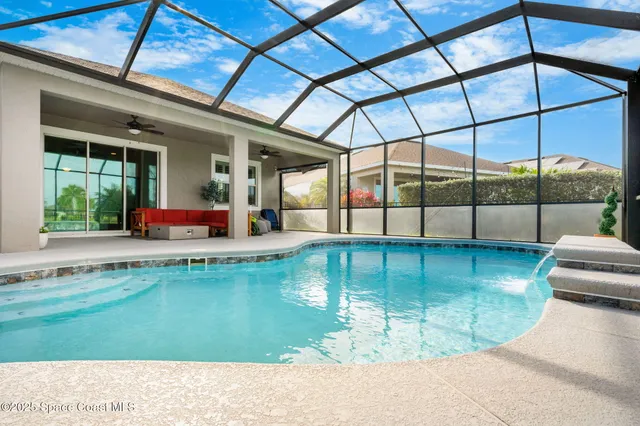 an aerial view of a house with swimming pool