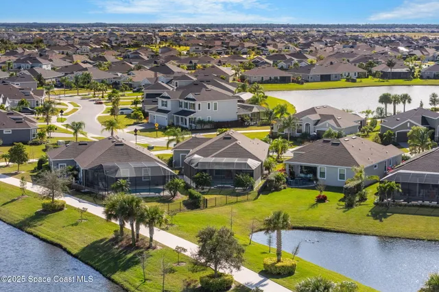 an aerial view of a house with a swimming pool yard and outdoor seating