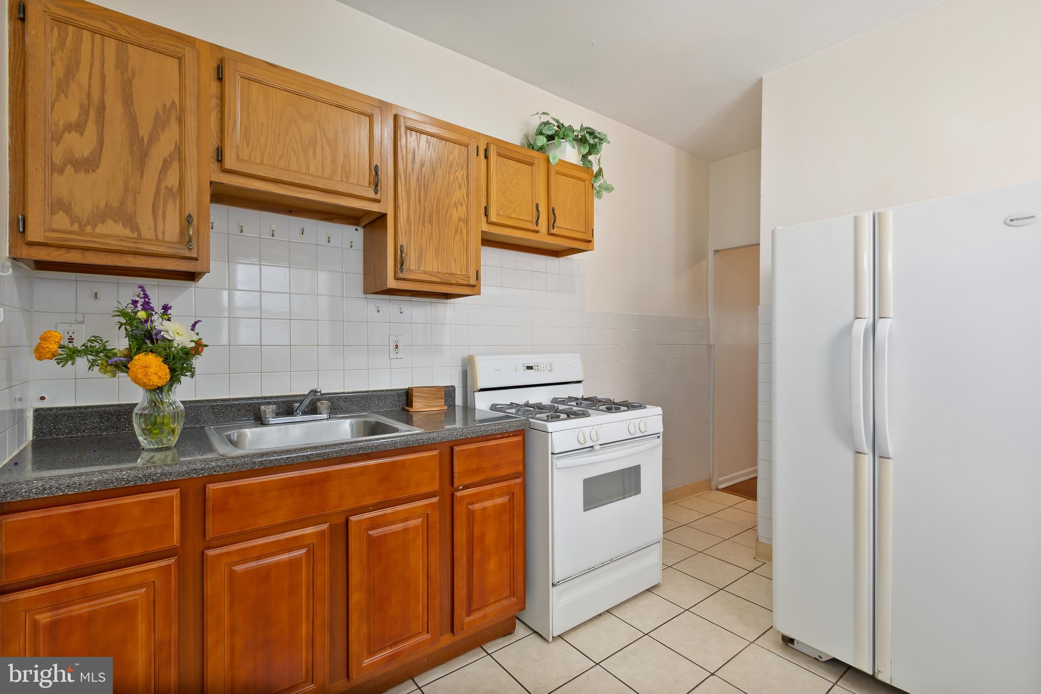 934 North Fourth Street Camden, NJ 08102 - Photo 12 of 34 a kitchen with stainless steel appliances granite countertop a sink stove and cabinets