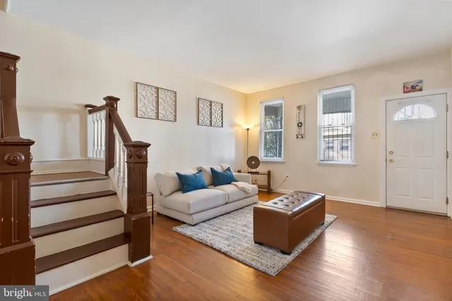 a living room with furniture and wooden floor