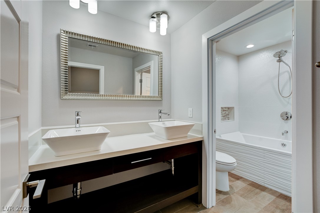 4207 Ridgecrest Drive Las Vegas, NV 89121 - Photo 20 of 27 Bathroom featuring upgraded double vanity, bathtub/shower combination, and recessed lighting