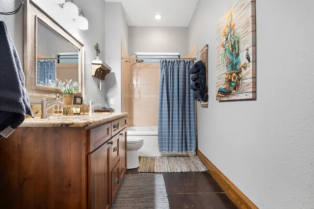 a bathroom with a sink a mirror and a shower