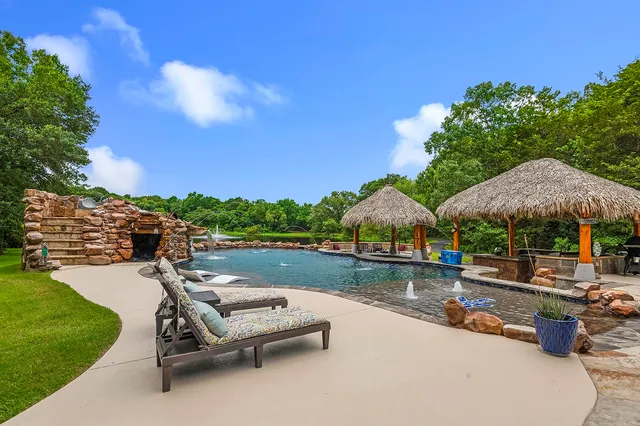 a view of swimming pool with outdoor seating and plants