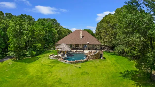a backyard of a house with table and chairs