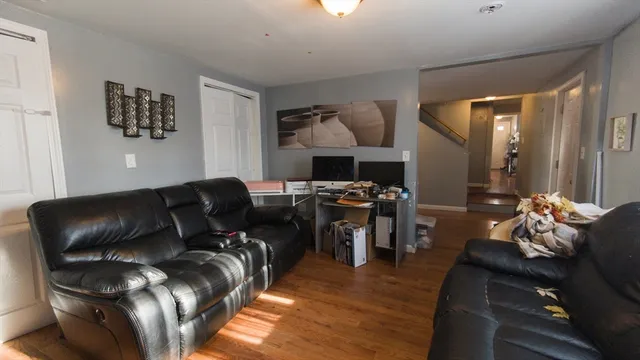a living room with furniture and wooden floor