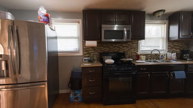 a kitchen with a refrigerator and a sink