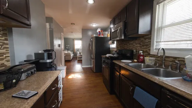 a kitchen with a sink stove and cabinets