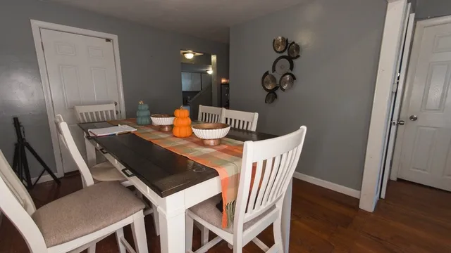 a view of a dining room with furniture and wooden floor