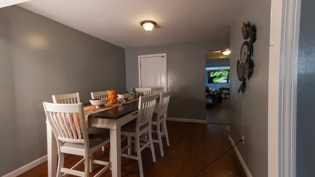 a view of a dining room with furniture and a chandelier