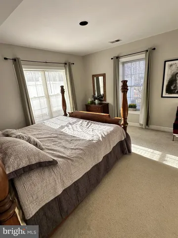 a bedroom with a large bed and a window