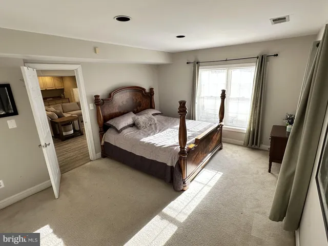 a living room with furniture and a mirror