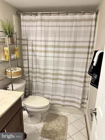 a bathroom with a toilet and shower