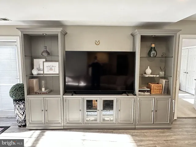 a living room with stainless steel appliances kitchen island granite countertop a refrigerator and a stove